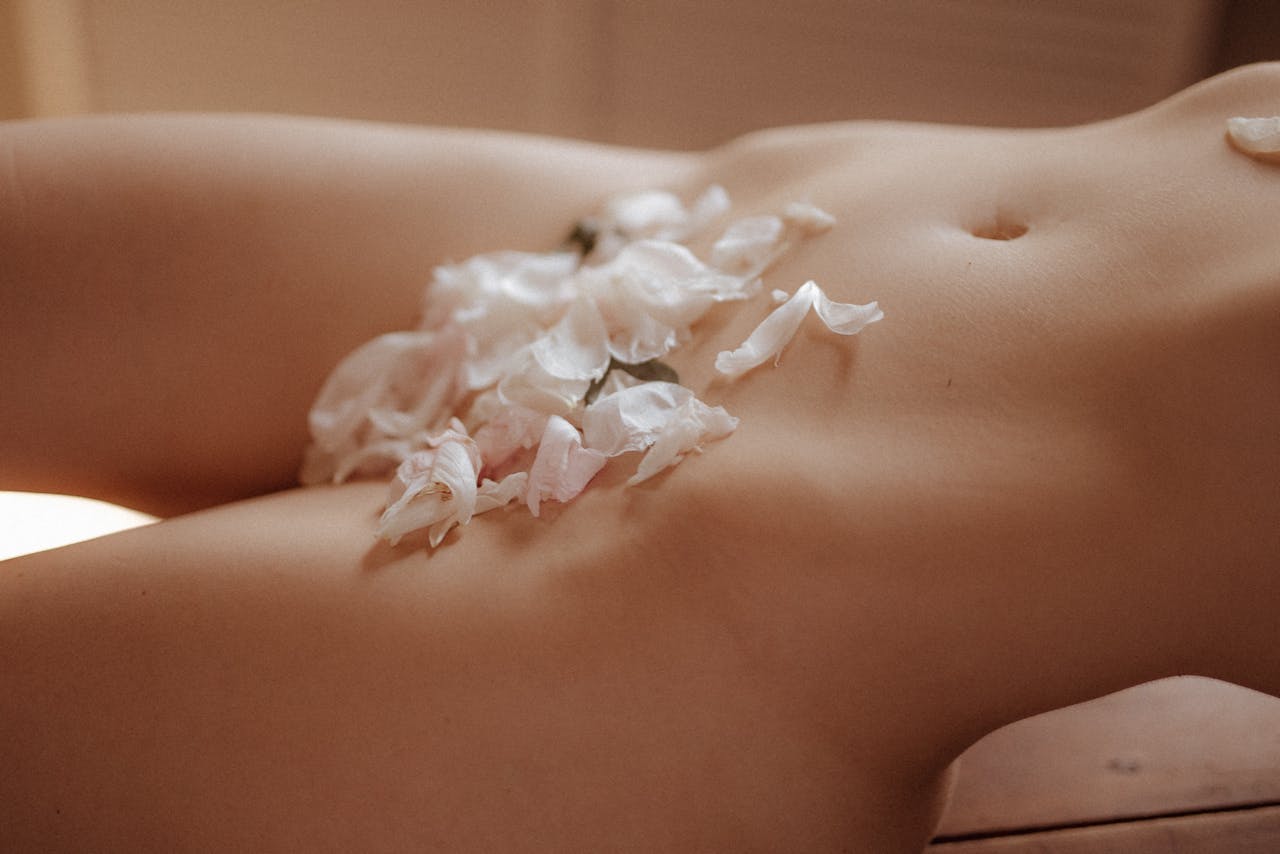 Naked Woman with Flower Petals Covering Parts of Her Body